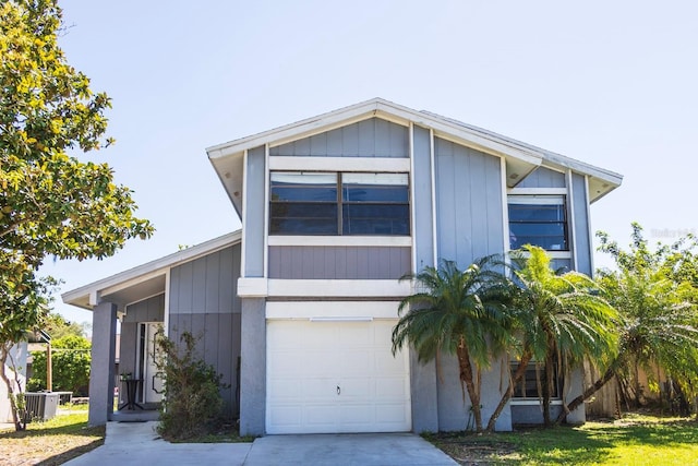 view of front of property featuring concrete driveway, an attached garage, and central AC unit