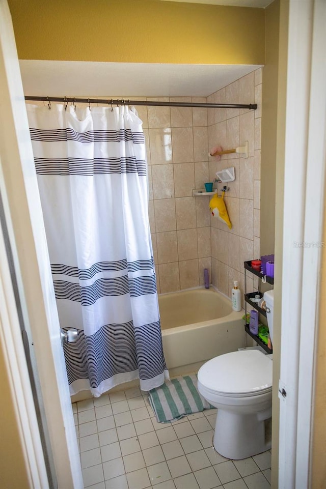 bathroom with tile patterned flooring, toilet, and shower / tub combo