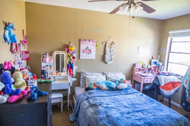 bedroom featuring a ceiling fan and a textured ceiling