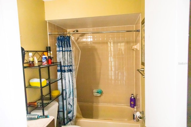 bathroom featuring shower / bath combo with shower curtain and toilet