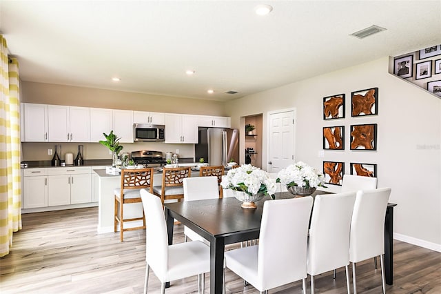 dining space with visible vents, recessed lighting, light wood-type flooring, and baseboards