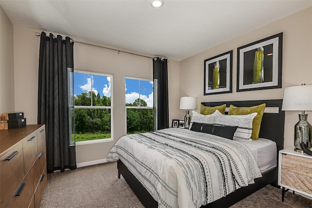 bedroom featuring carpet flooring and baseboards