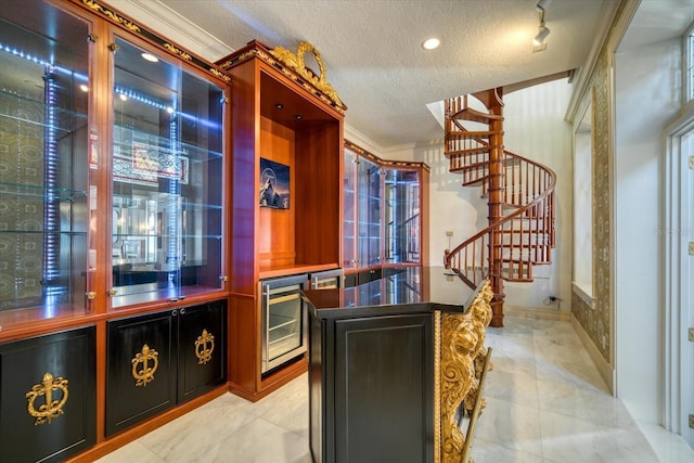 bar featuring beverage cooler, a textured ceiling, crown molding, indoor bar, and stairs