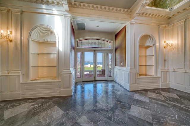 entryway with a decorative wall, french doors, marble finish floor, and ornamental molding