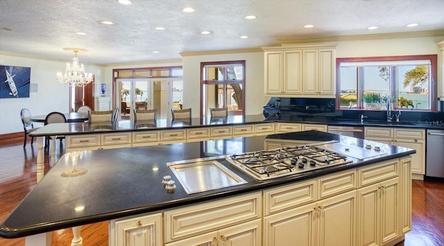 kitchen featuring cream cabinets, dark countertops, and dishwasher
