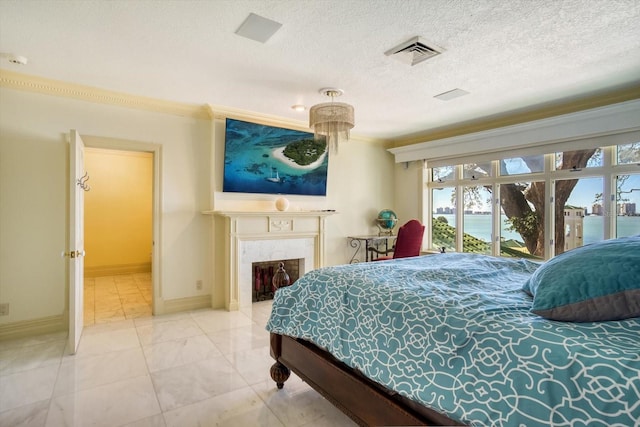 bedroom with a high end fireplace, visible vents, baseboards, a textured ceiling, and access to outside