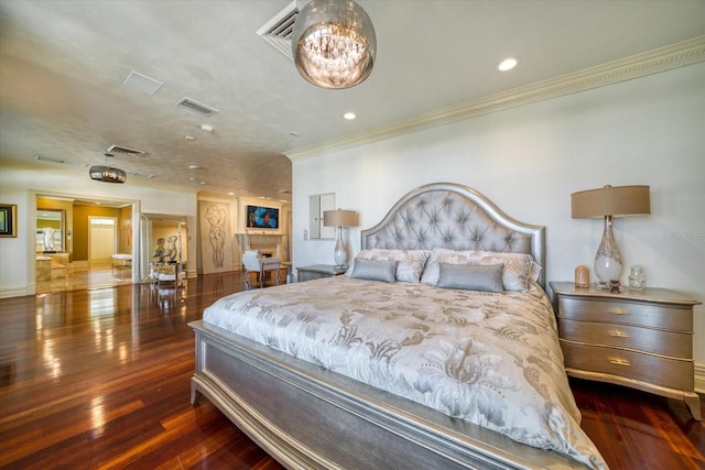 bedroom with recessed lighting, visible vents, wood finished floors, and ornamental molding