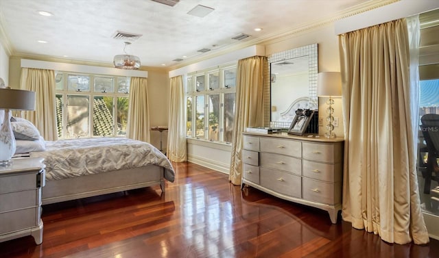 bedroom featuring visible vents, dark wood-type flooring, baseboards, and ornamental molding