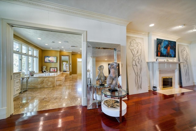 interior space with recessed lighting, wood finished floors, and crown molding