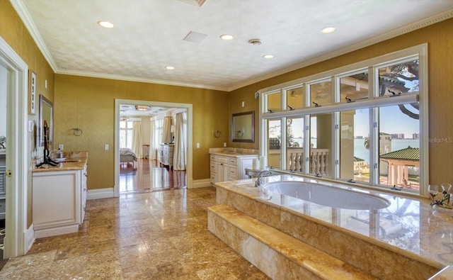 bathroom with vanity, a garden tub, a healthy amount of sunlight, and ornamental molding
