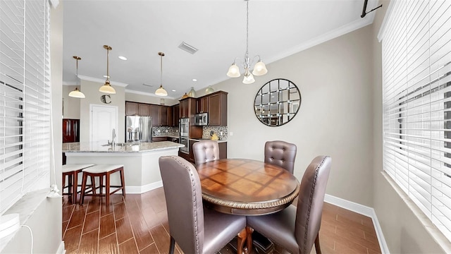 5324 Moon Shell Dr, Apollo Beach, FL 33572 - dining space featuring plenty of natural light, a chandelier, dark wood-type flooring, crown molding, and recessed lighting
