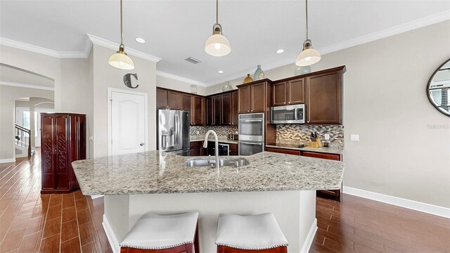 5324 Moon Shell Dr, Apollo Beach, FL 33572 - kitchen featuring appliances with stainless steel finishes, a sink, dark wood-type flooring, baseboards, and crown molding