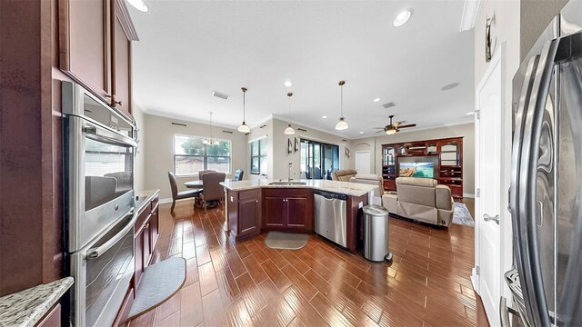 5324 Moon Shell Dr, Apollo Beach, FL 33572 - kitchen with appliances with stainless steel finishes, open floor plan, a sink, recessed lighting, and dark wood-style floors
