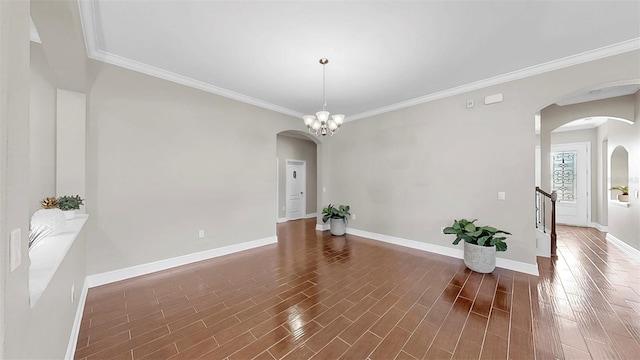 5324 Moon Shell Dr, Apollo Beach, FL 33572 - spare room featuring arched walkways, baseboards, crown molding, and dark wood finished floors