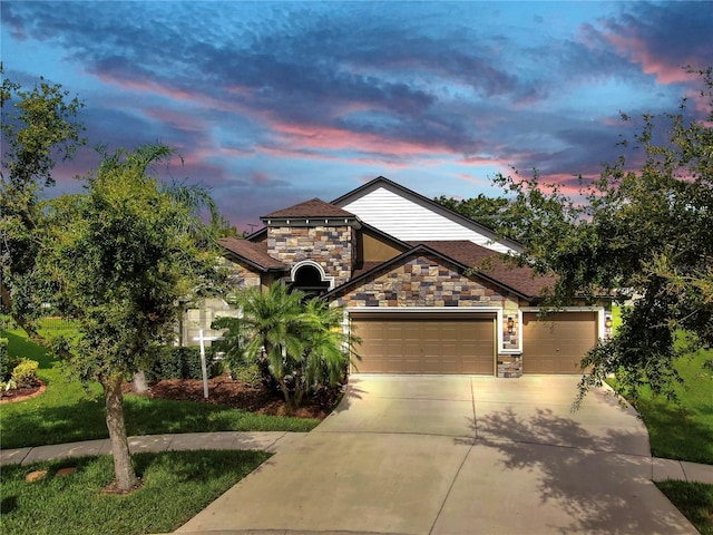 5324 Moon Shell Dr, Apollo Beach, FL 33572 - view of front of home featuring stone siding, driveway, and an attached garage