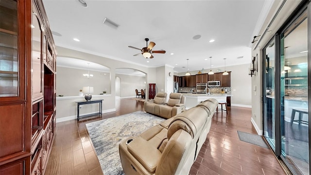 5324 Moon Shell Dr, Apollo Beach, FL 33572 - living area featuring arched walkways, dark wood finished floors, ceiling fan, baseboards, and recessed lighting