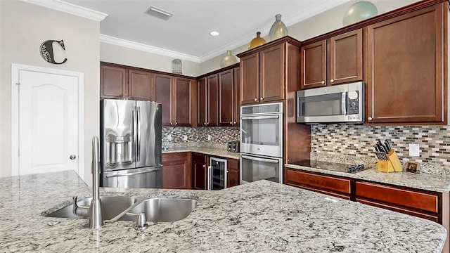 5324 Moon Shell Dr, Apollo Beach, FL 33572 - kitchen with stainless steel appliances, wine cooler, crown molding, light stone countertops, and tasteful backsplash