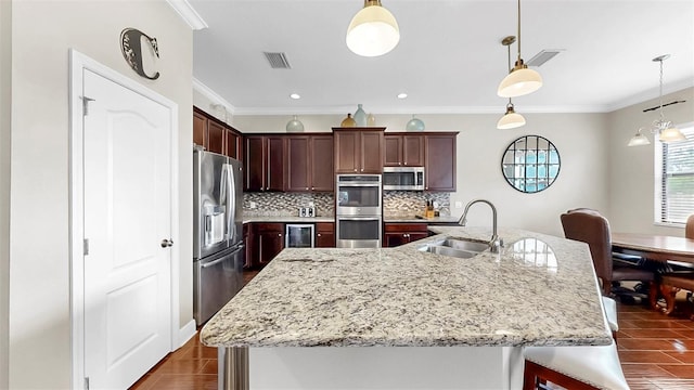 5324 Moon Shell Dr, Apollo Beach, FL 33572 - kitchen with appliances with stainless steel finishes, a sink, decorative backsplash, beverage cooler, and hanging light fixtures