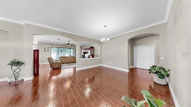 5324 Moon Shell Dr, Apollo Beach, FL 33572 - unfurnished living room featuring arched walkways, a ceiling fan, dark wood-style floors, ornamental molding, and baseboards