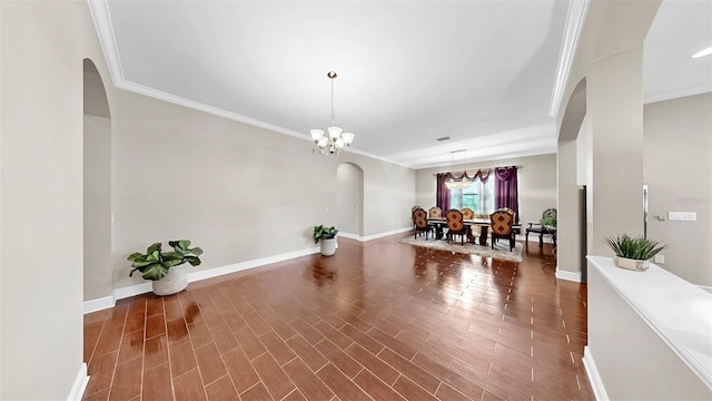 5324 Moon Shell Dr, Apollo Beach, FL 33572 - interior space with arched walkways, crown molding, a chandelier, baseboards, and wood finished floors