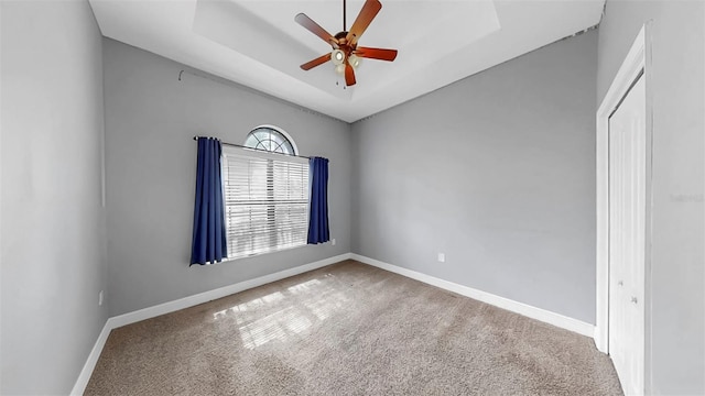 5324 Moon Shell Dr, Apollo Beach, FL 33572 - spare room featuring carpet, a ceiling fan, baseboards, and a raised ceiling