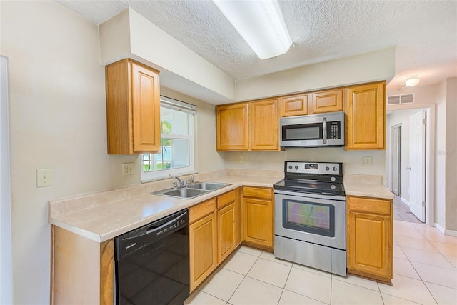 kitchen with visible vents, light countertops, appliances with stainless steel finishes, light tile patterned flooring, and a sink