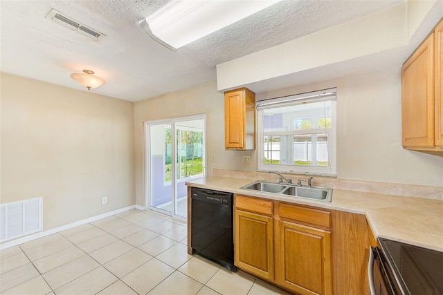 kitchen with dishwasher, light countertops, visible vents, and a sink