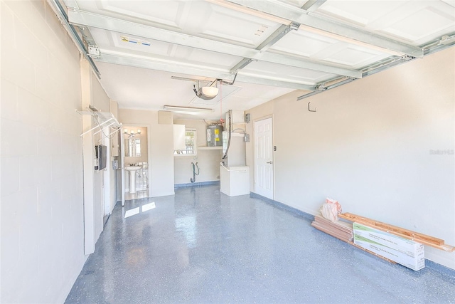 garage featuring concrete block wall and a garage door opener