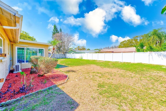 view of yard with ac unit and fence