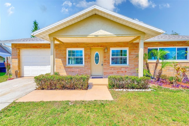 view of front of home featuring concrete driveway, an attached garage, and a front yard