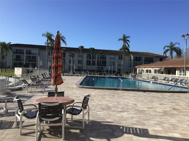 pool featuring a patio and fence