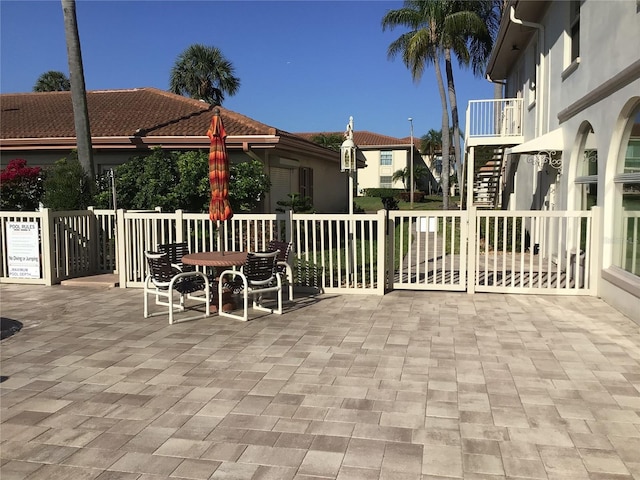 view of patio featuring stairway and outdoor dining area