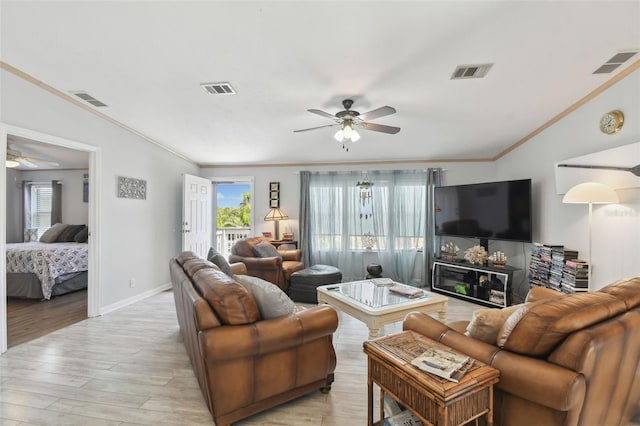 living room featuring visible vents, light wood-type flooring, ceiling fan, and ornamental molding