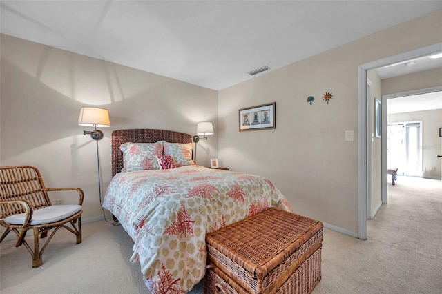 bedroom featuring visible vents, light colored carpet, and baseboards