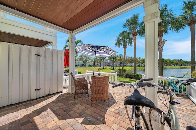 view of patio featuring outdoor dining area and a water view