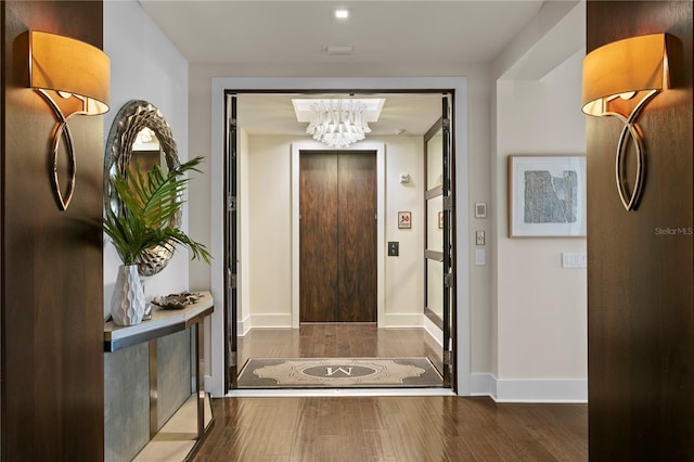 146 4th Ave NE Unit 600, Saint Petersburg, FL 33701 - hall with an inviting chandelier, baseboards, and wood finished floors