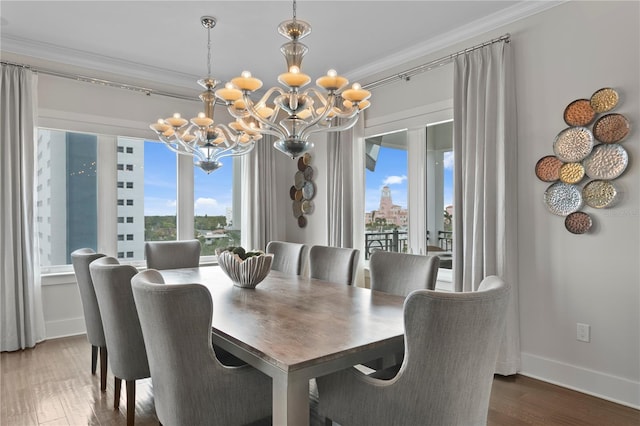 146 4th Ave NE Unit 600, Saint Petersburg, FL 33701 - dining space featuring ornamental molding, wood finished floors, a chandelier, and a wealth of natural light