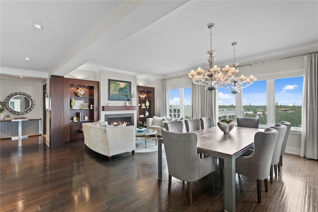 146 4th Ave NE Unit 600, Saint Petersburg, FL 33701 - dining area featuring a warm lit fireplace, dark wood-style flooring, crown molding, baseboards, and an inviting chandelier