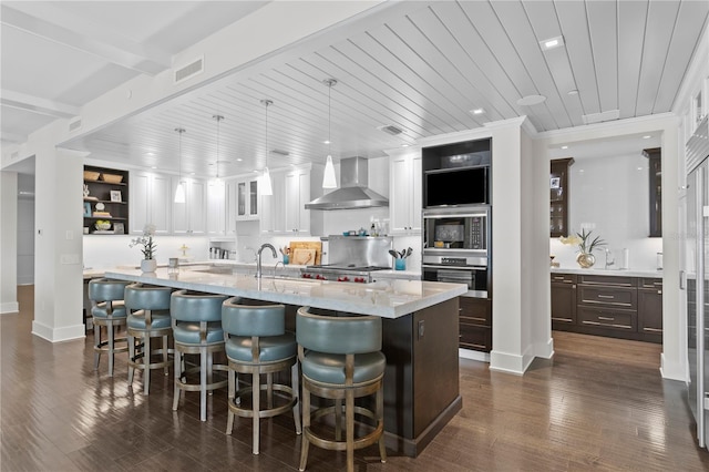 146 4th Ave NE Unit 600, Saint Petersburg, FL 33701 - kitchen with white cabinetry, open shelves, dark wood-style floors, visible vents, and wall chimney exhaust hood