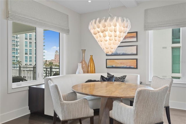 146 4th Ave NE Unit 600, Saint Petersburg, FL 33701 - dining area featuring dark wood-type flooring, baseboards, and a chandelier