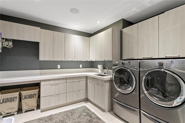 146 4th Ave NE Unit 600, Saint Petersburg, FL 33701 - washroom with light tile patterned floors, a sink, washer and clothes dryer, and cabinet space