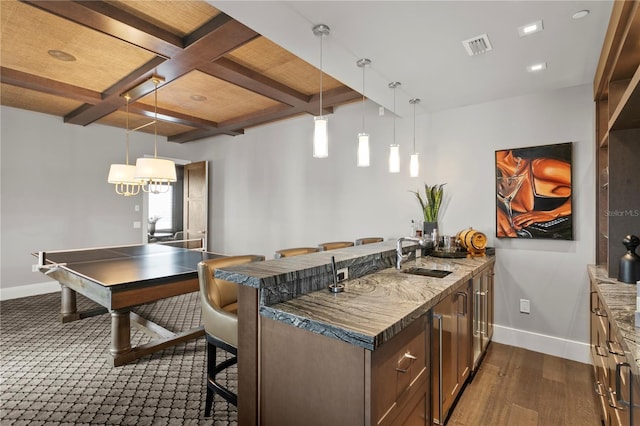 146 4th Ave NE Unit 600, Saint Petersburg, FL 33701 - kitchen with beamed ceiling, baseboards, a kitchen bar, a sink, and coffered ceiling
