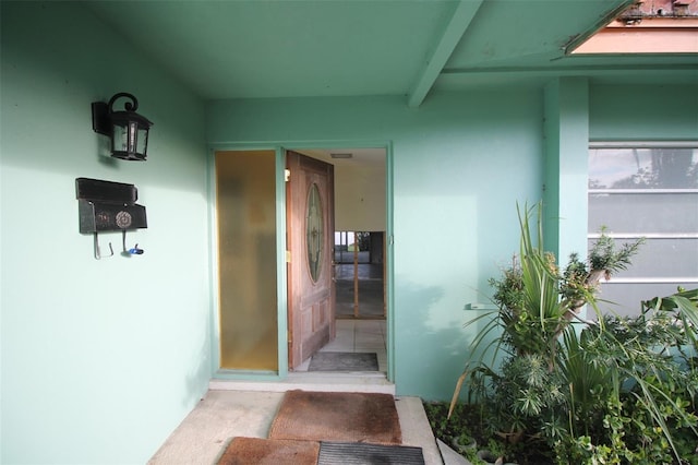 property entrance featuring stucco siding