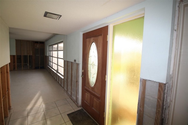 foyer entrance with light tile patterned flooring