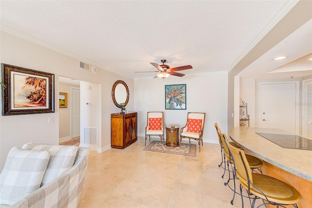 interior space featuring ceiling fan, crown molding, visible vents, and a textured ceiling