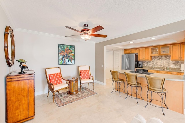 kitchen with a kitchen bar, backsplash, freestanding refrigerator, light countertops, and glass insert cabinets