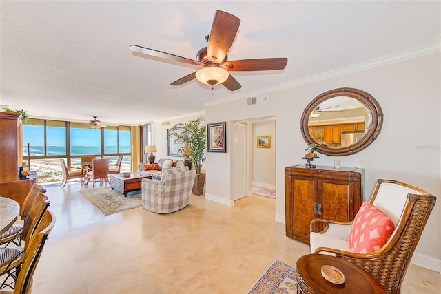 living room featuring ornamental molding, baseboards, ceiling fan, and expansive windows