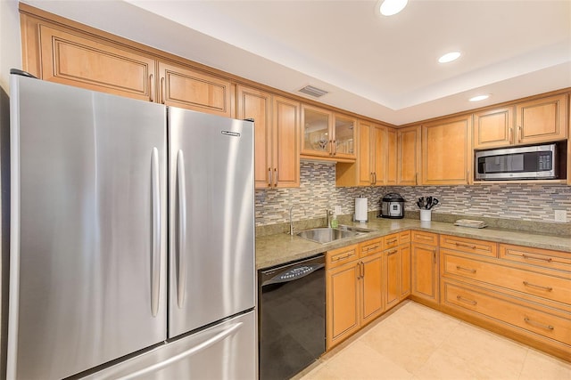 kitchen with tasteful backsplash, visible vents, light tile patterned floors, stainless steel appliances, and a sink