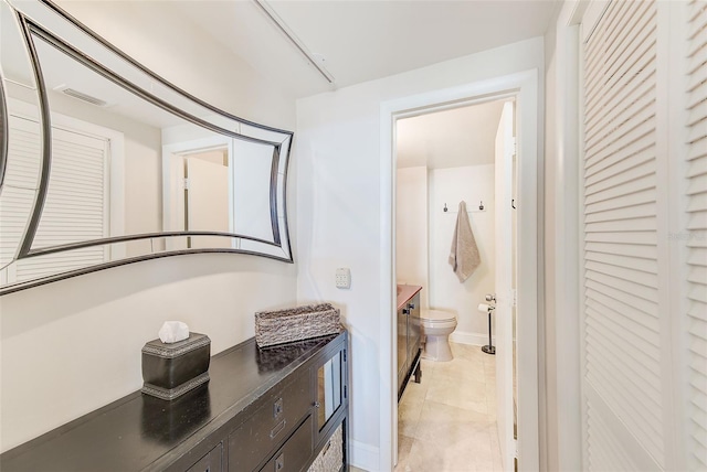 bathroom with visible vents, baseboards, toilet, tile patterned floors, and vanity