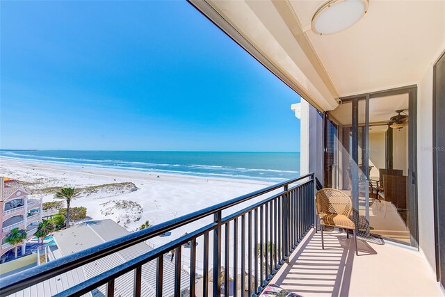 balcony featuring a beach view and a water view